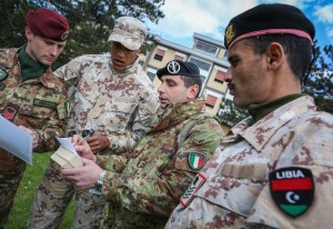 ITALY, Cassino: In a photograph taken and released by the Warrior Affairs Commission (WAC) 07 March 2014, soldiers of the Libyan National Army and trainers from the Italian military study maps during a training exercise at a military base in the town of Cassino, approx. 130km south-east of the Italian capital Rome. As part of an internationally-supported programme to rebuild Libya's armed forces, the Italian military are training former opposition forces who fought to overthrow the former regime of Col. Muammar Gadaffi in 2011. The 14-week course, which began in January and is currently training 340 soldiers from the north African country, will train several thousand personnel from the Libya National Army over the coming months in basic military practise incorporating weapons handling, tactical movement, navigation, cordon and search, as well as physical training, IT and functioning as cohesive, coordinated military units. WAC PHOTO / STUART PRICE.